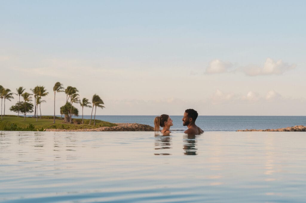 AUL - Couple Relaxing Pool Shot Aulani - Infinity Pool overlooking the ocean